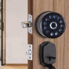 circular fingerprint keypad smart deadbolt installed on wooden entry door