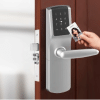 silver RFID hotel smart lock with keypad and curved lever on a wooden door