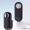 Retrofit smart lock with minimalist oval design and silver thumb‑turn on a clean pedestal