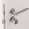 Smart electronic cylinder installed on a modern door with lever handle